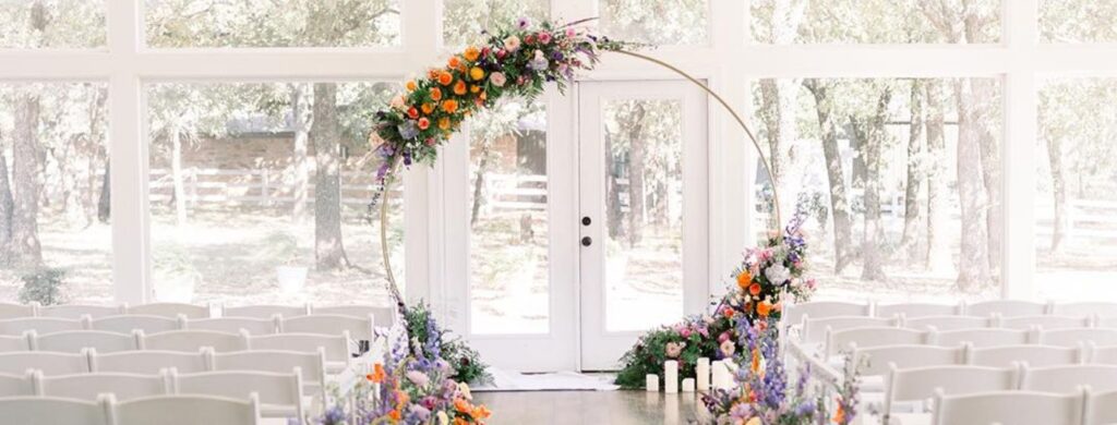 A beautiful shot of a wedding arch with vibrant flowers.