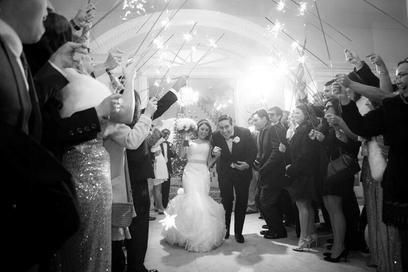 bride and groom leaving past wedding guests
