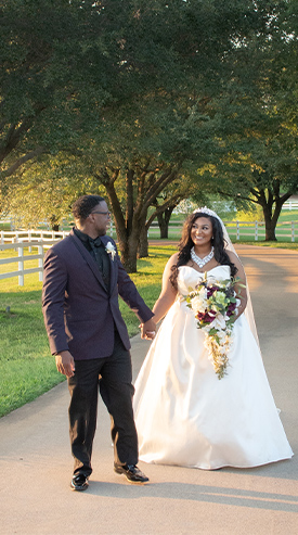 bride and groom walking down a path