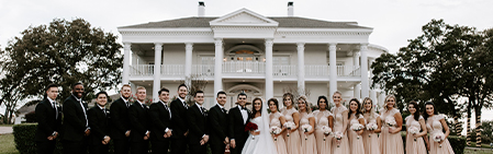 bridal party in front of Lone Star Mansion