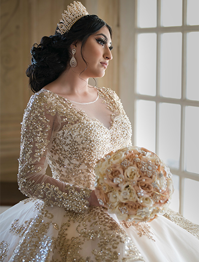 girl looking out the window in her Quinceañera dress