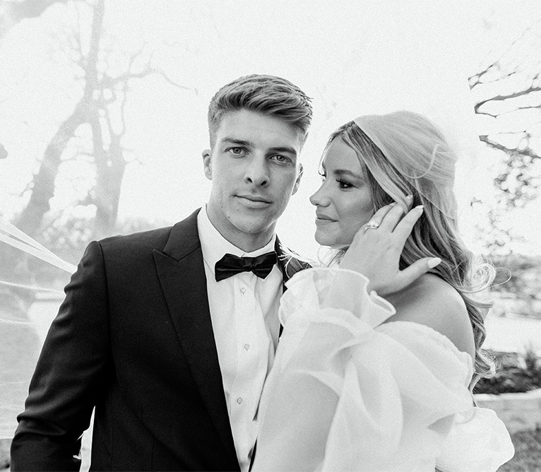 a bride looking at a groom and groom looking at camera