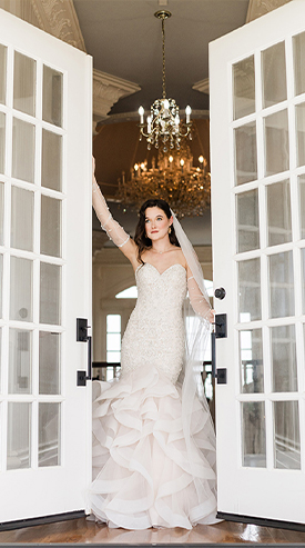 a bride standing between French doors