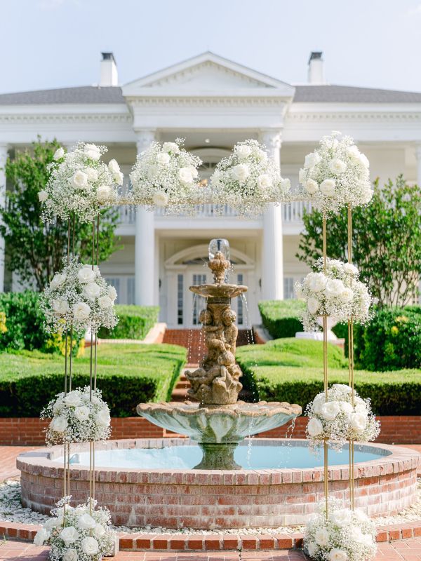 A beautiful shot of the mansion with a wedding arch. 