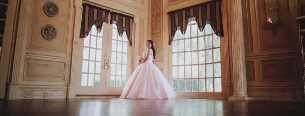 A picture of a beautiful young lady in the ballroom. 